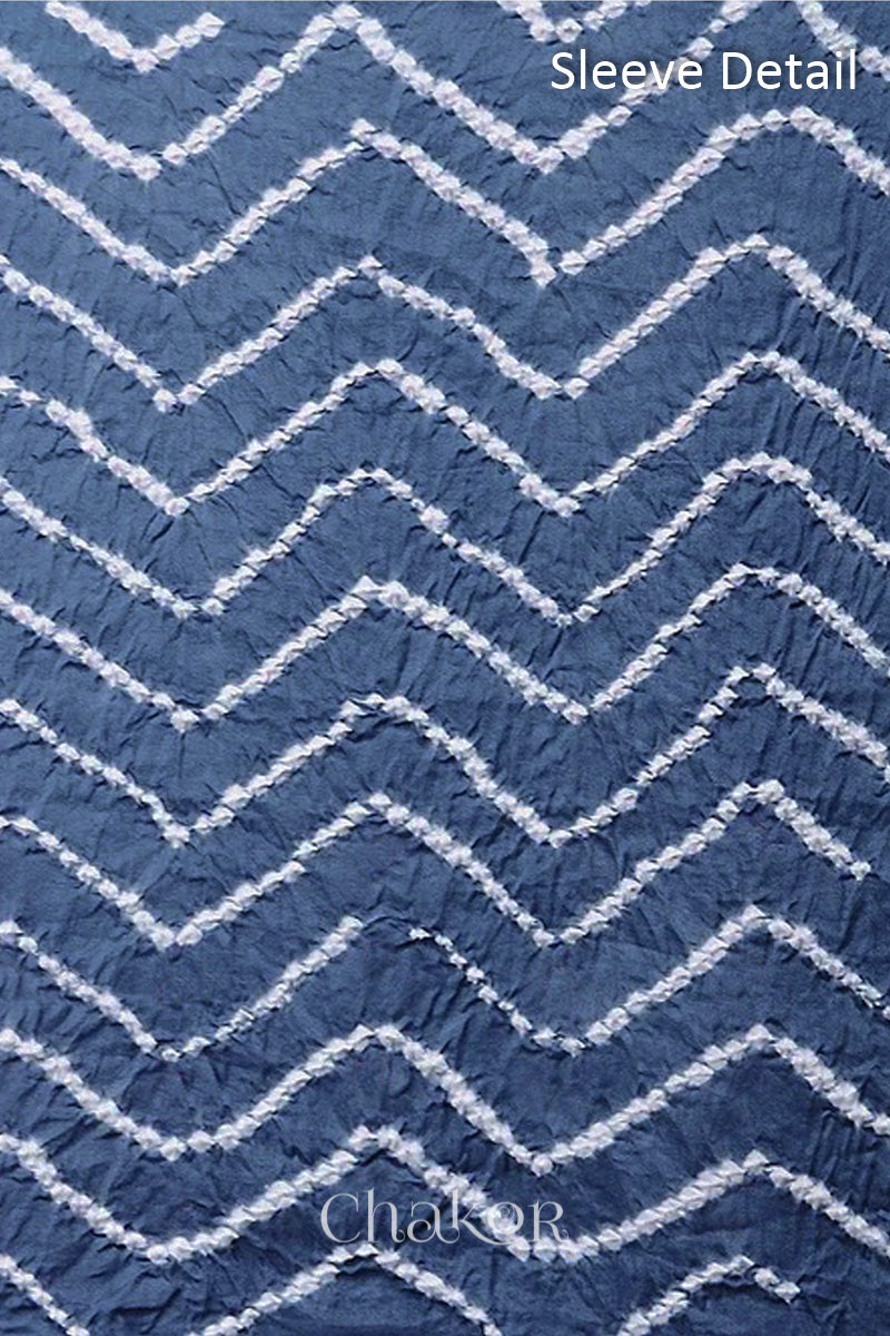 Close-up of bandhani sleeve detail featuring chevron tie-dye design, with Chakor brand logo.
