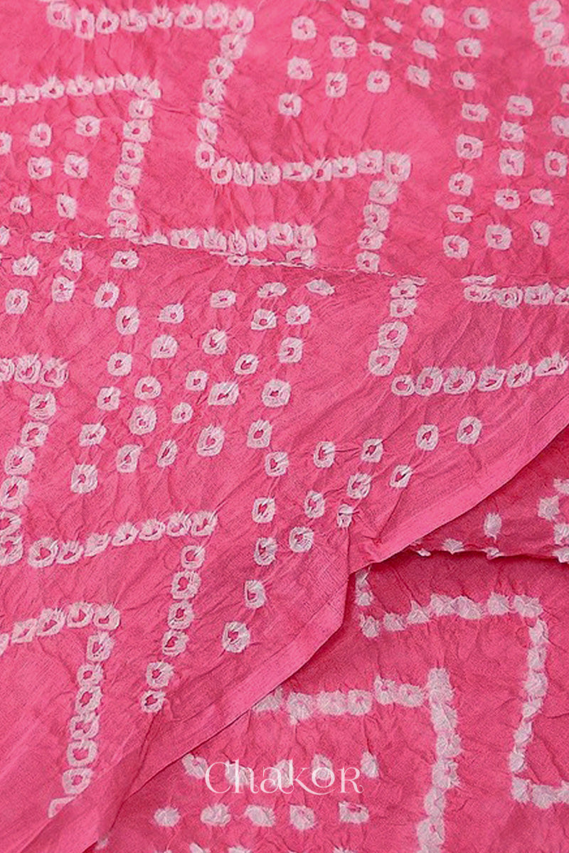 Close up of pink cotton mul dupatta featuring intricate white zigzag bandhani dot patterns, showcasing traditional design.
