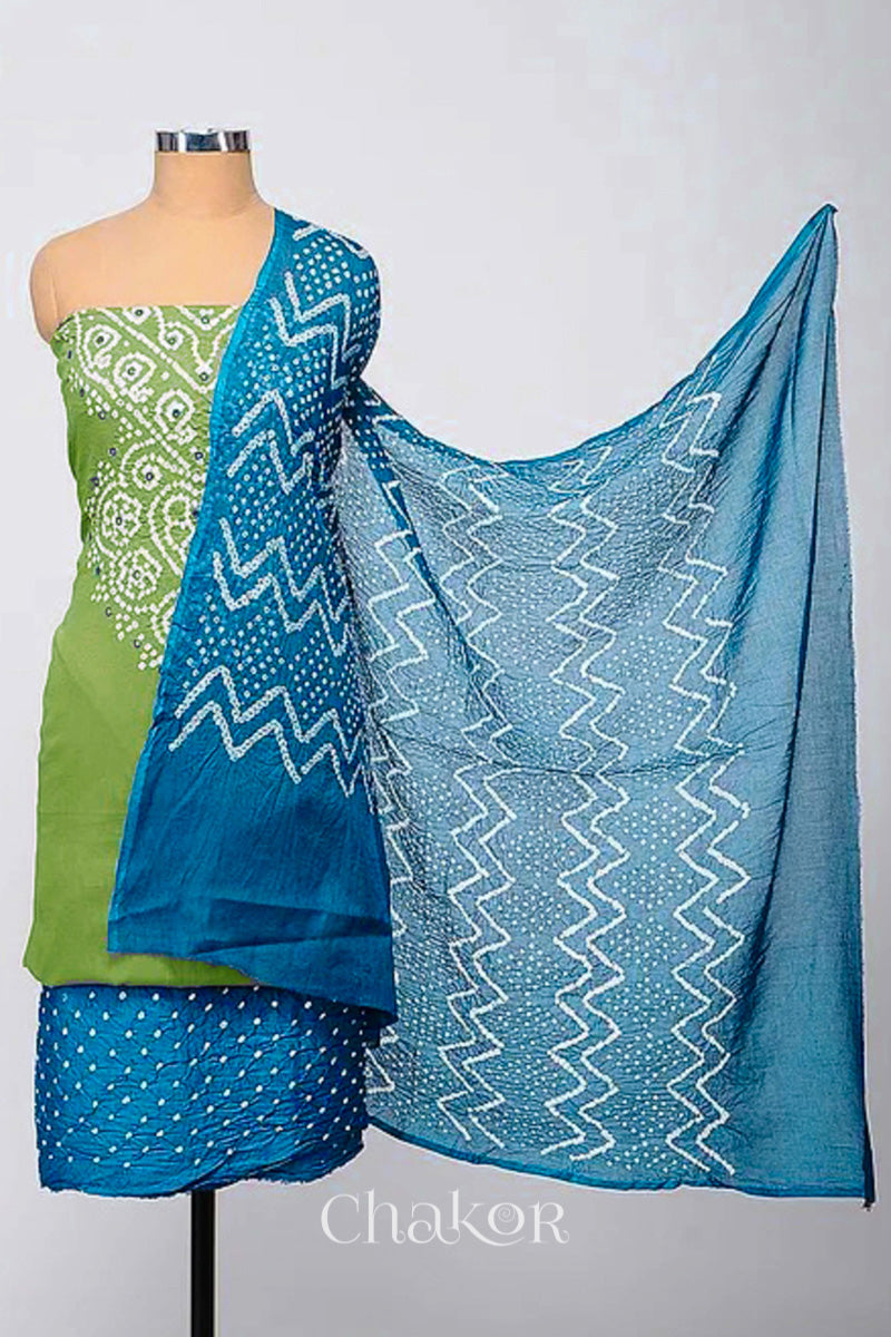 A stylish kurta set fabric featuring a mehendi green mirror embroidered top, a bandhani turquoise blue bottom, and a matching turquoise blue dupatta draped elegantly. Text reads Chakor.
