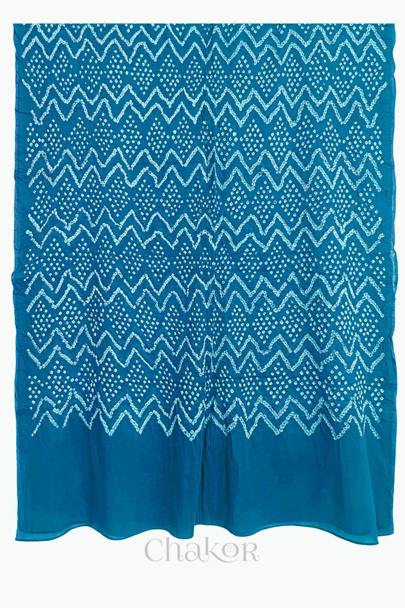 A turquoise blue cotton mul dupatta featuring intricate white zigzag bandhani dot patterns, showcasing traditional design.
