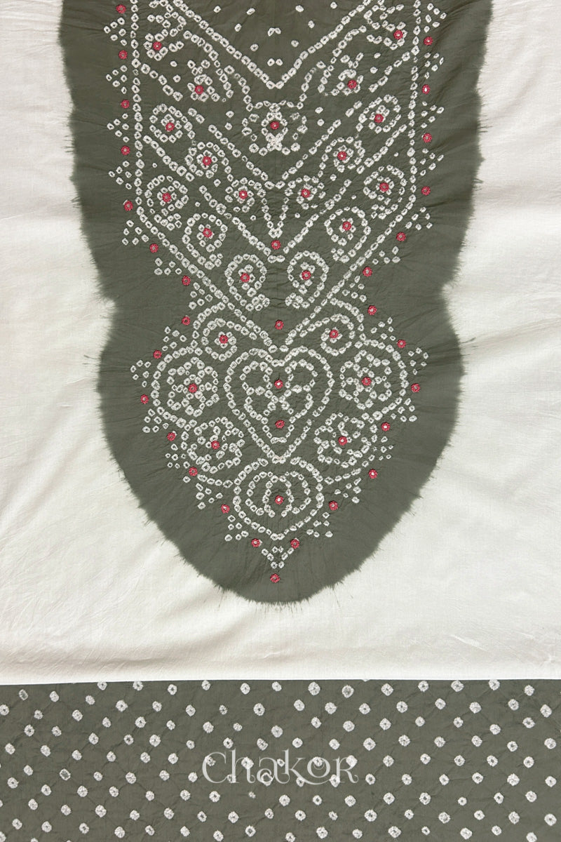 Close-up of tie dyed grey yoke on white kurta fabric featuring intricate bandhani and embroidered patterns with grey bandhani dotted bottom fabric, with Chakor brand logo.
