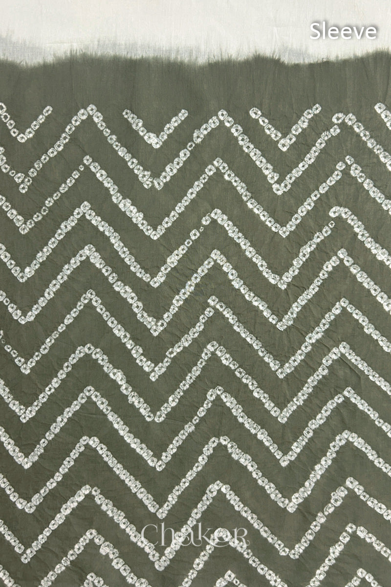 Close-up of bandhani fabric featuring chevron tie-dye design, with Chakor brand logo. Text reads sleeve details.
