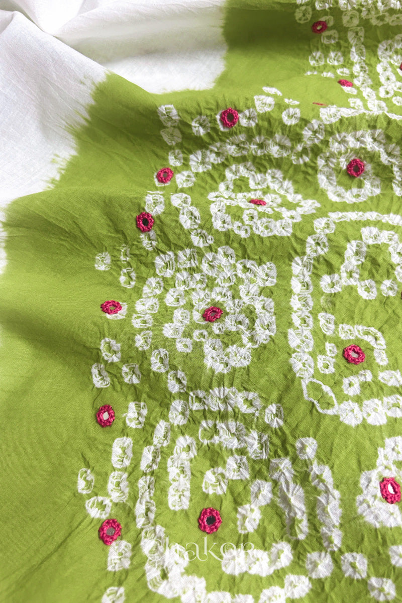 Close-up of Lime-white fabric adorned with intricate traditional bandhani patterns and pink mirror embroidery, showcasing beautiful craftsmanship.