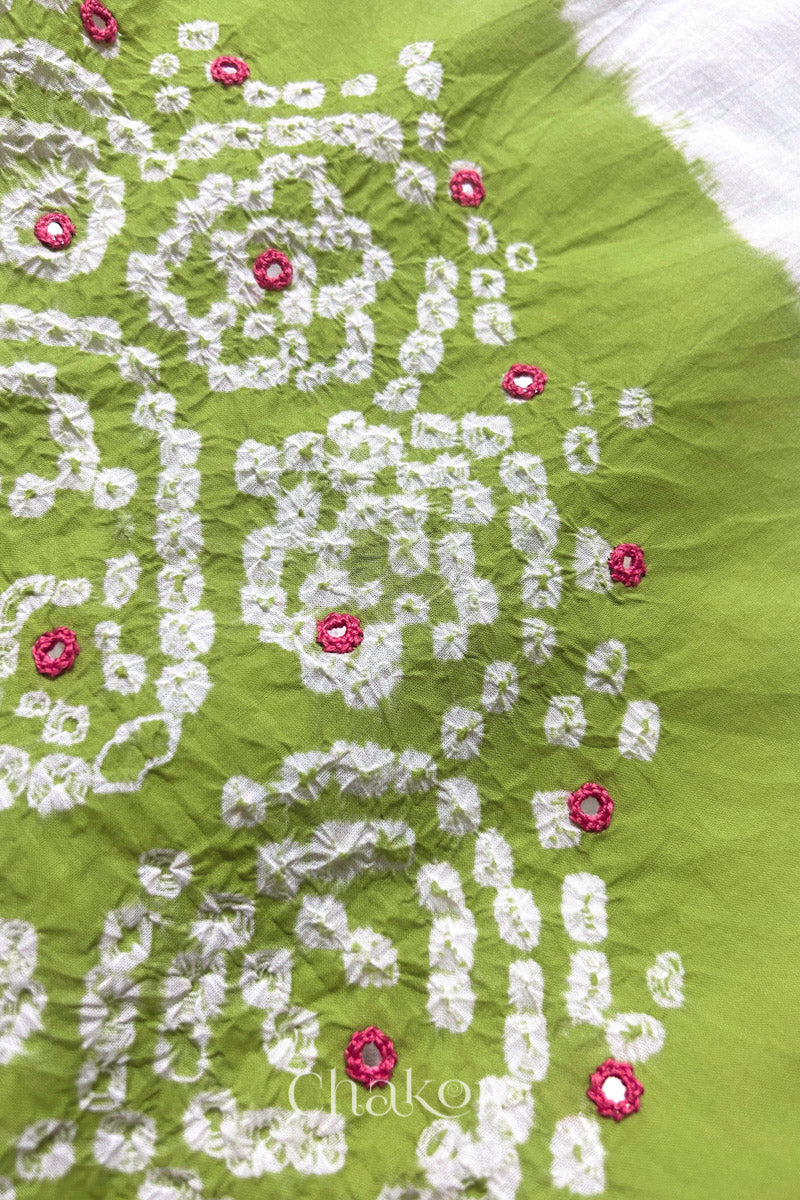 Close-up of Lime-white fabric adorned with intricate traditional bandhani patterns and pink mirror embroidery, showcasing beautiful craftsmanship.