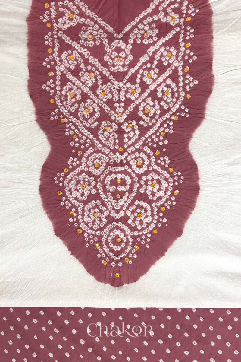 Close-up of tie dyed soft rose pink yoke on white kurta fabric featuring intricate bandhani and embroidered patterns with soft rose pink bandhani dotted bottom fabric, with Chakor brand logo.