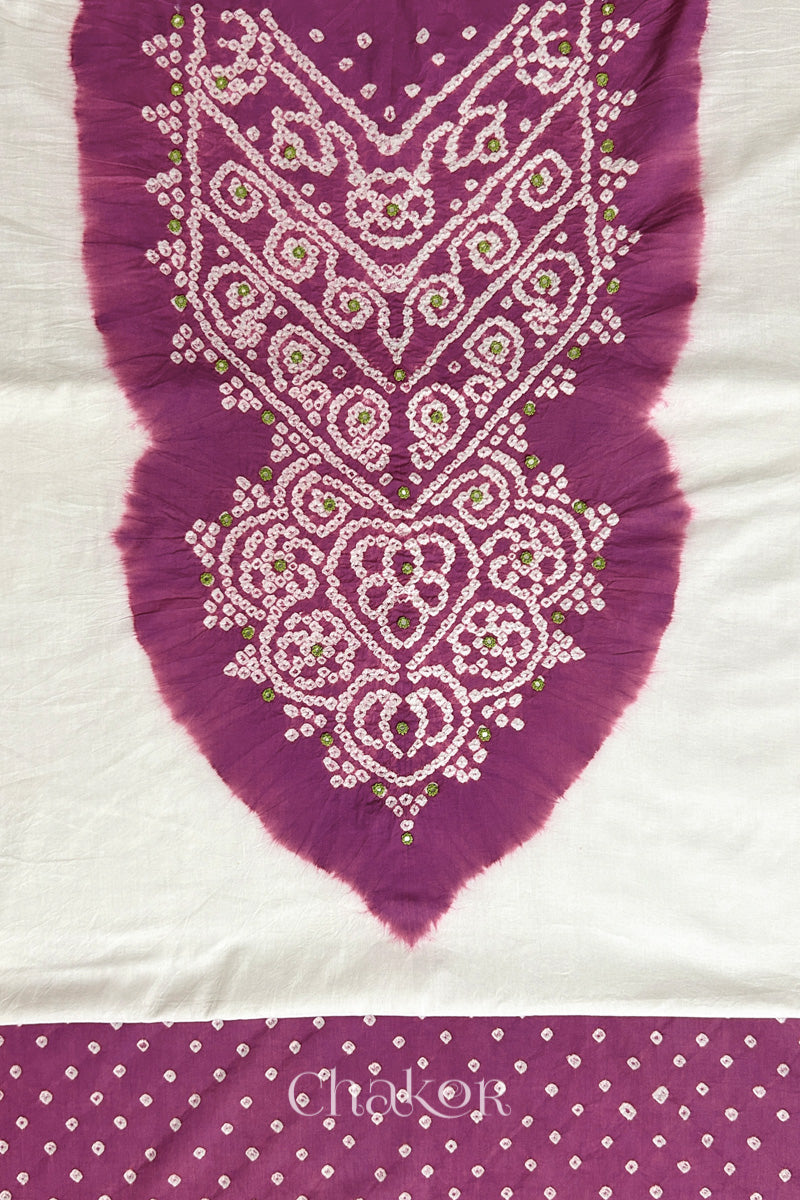 Close-up of tie dyed deep violet yoke on white kurta fabric featuring intricate bandhani and embroidered patterns with deep violet bandhani dotted bottom fabric, with Chakor brand logo.