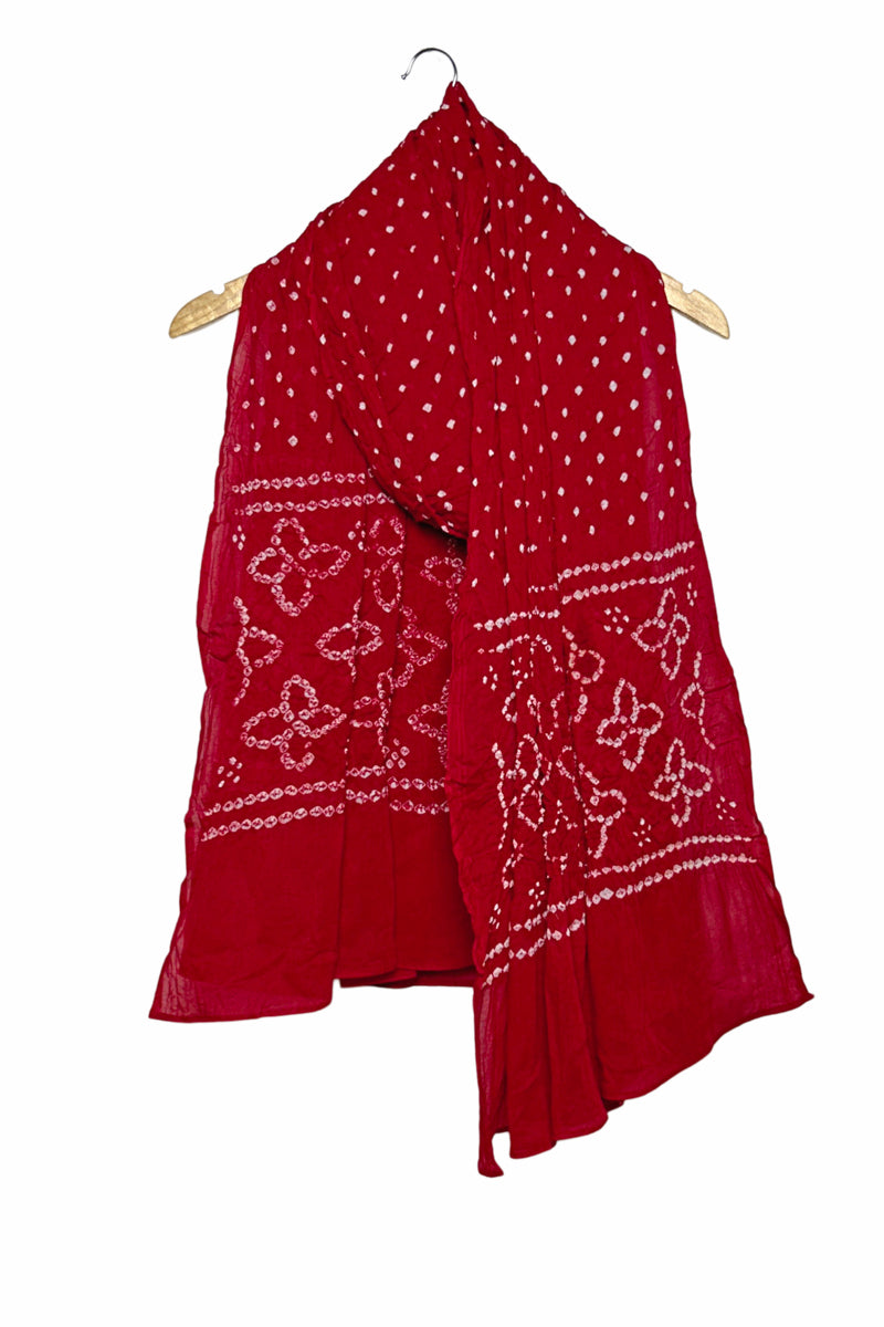 Red mercerised mulmul cotton dupatta with Bandhani floral pallu design draped on hanger.
