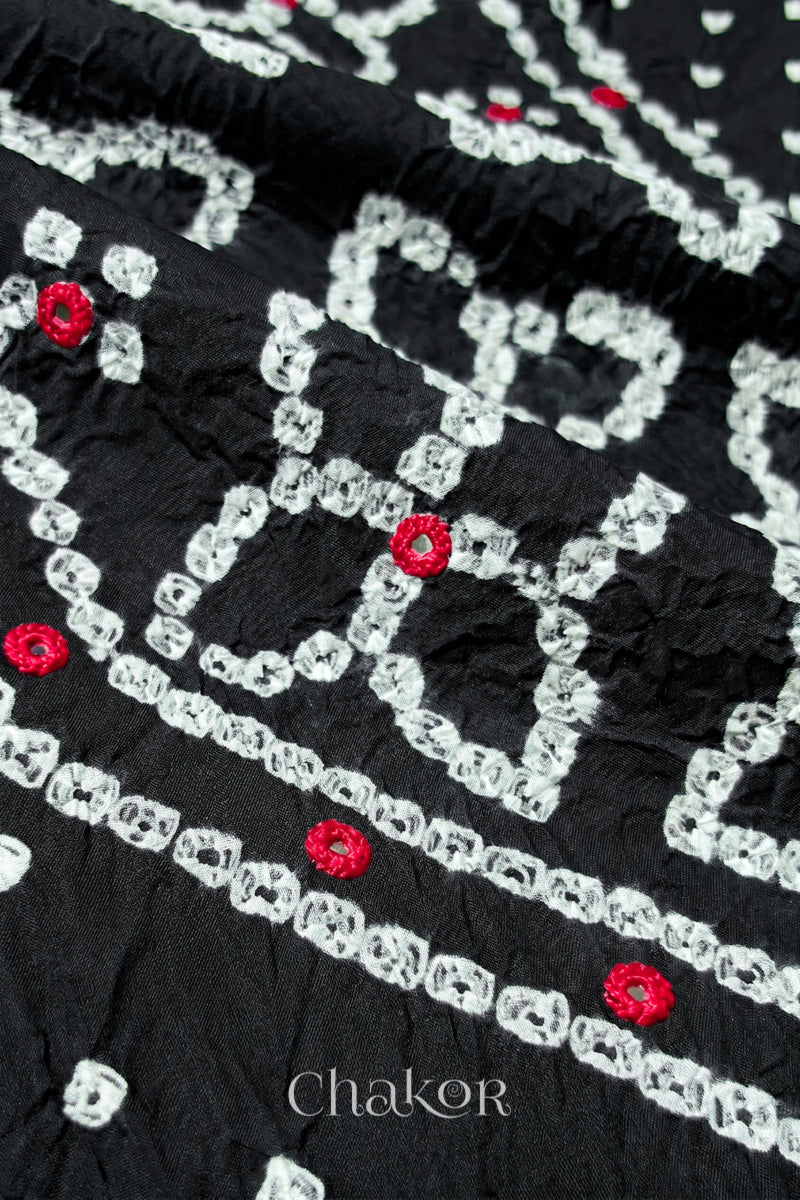 Hand tied Bandhani floral motif with colourful mirror embroidery on Black cotton fabric.
