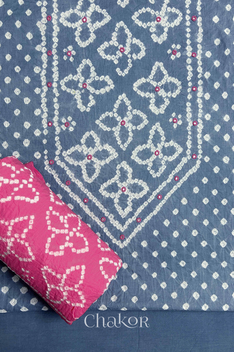 Front yoke detail of Grey Bandhani cotton kurta fabric with hand embroidery and mirror work and Pink dupatta rolled up.
