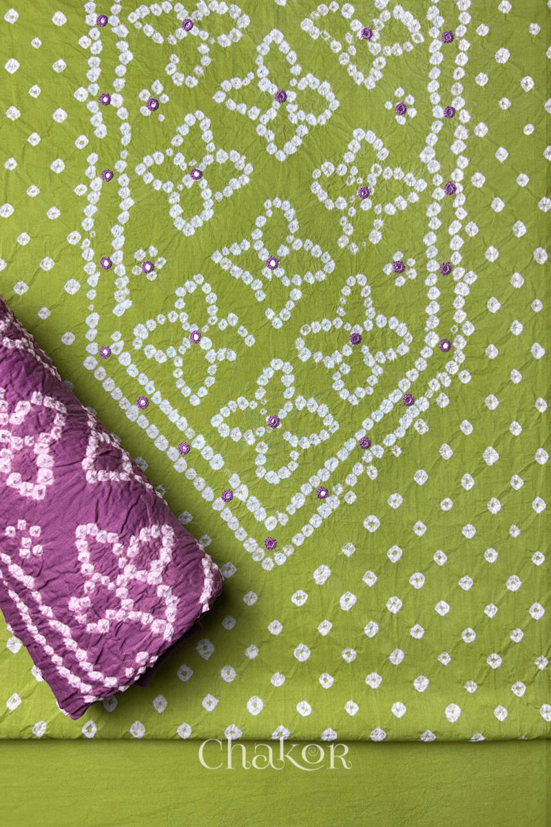 Front yoke detail of Green Bandhani cotton kurta fabric with hand embroidery and mirror work and Mauve dupatta rolled up.
