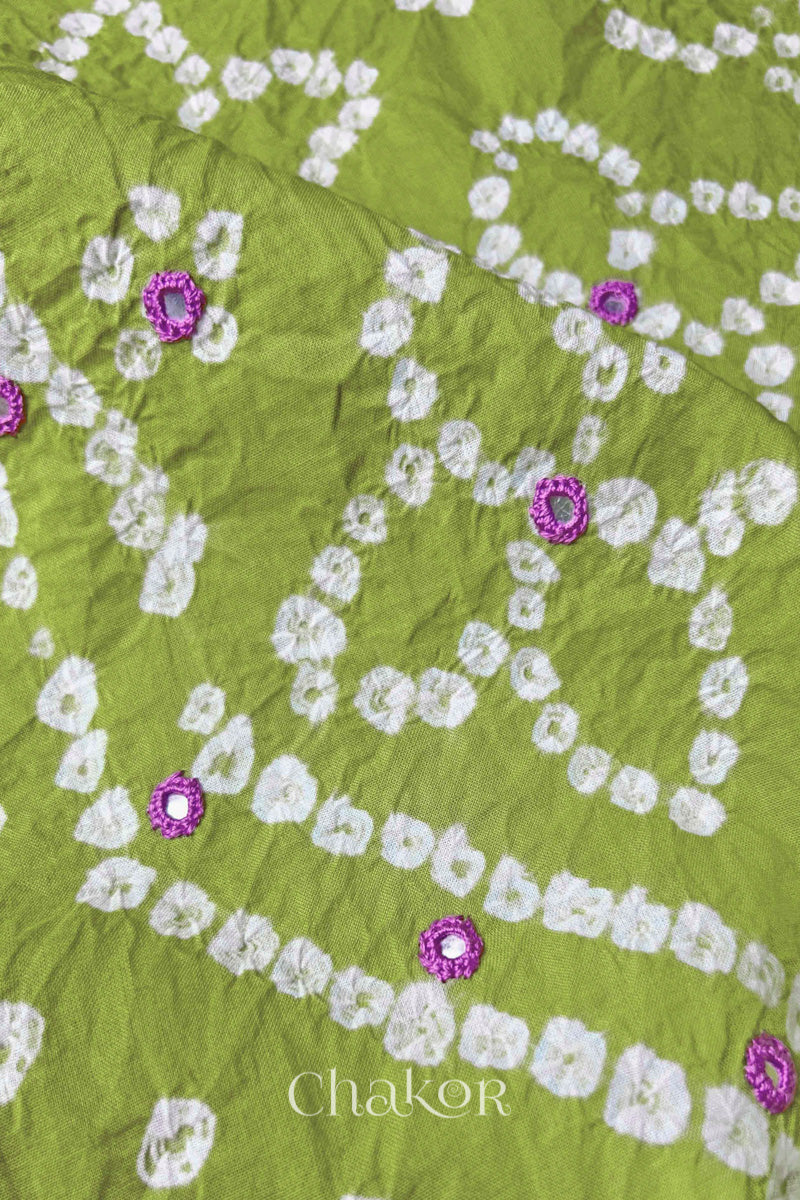 Close-up of Bandhani floral pattern accented with hand embroidery Green mirror work.
