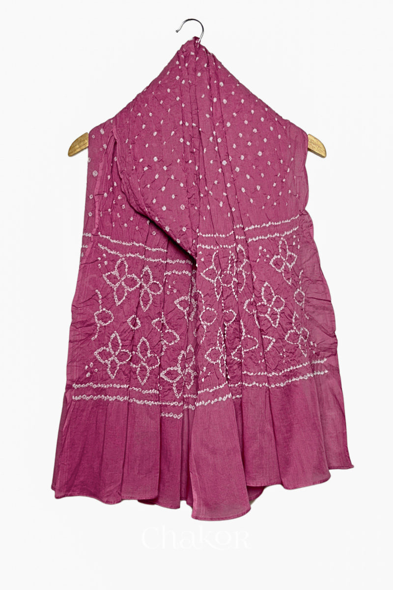 Old Rose mercerised mulmul cotton dupatta with Bandhani floral pallu design draped on hanger.
