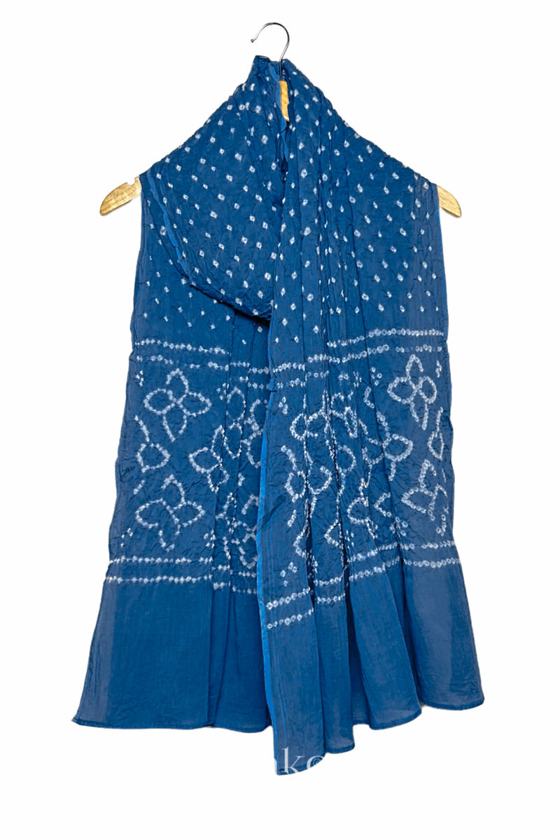 Indigo Blue mercerised mulmul cotton dupatta with Bandhani floral pallu design draped on hanger.
