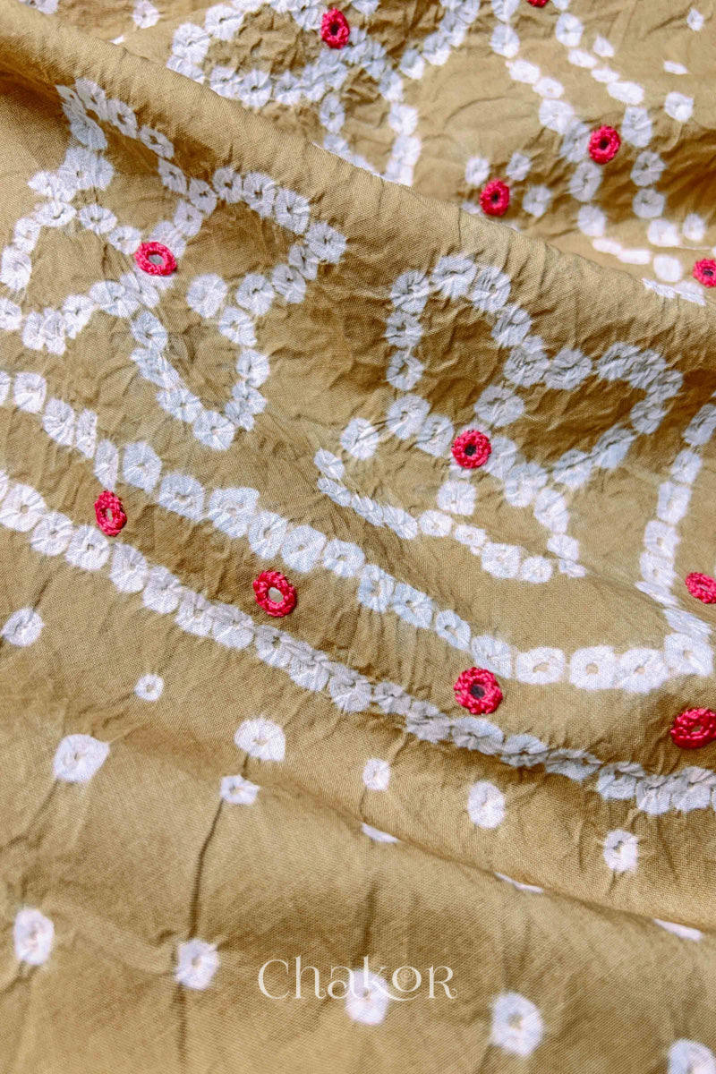 Hand tied Bandhani floral motif with colourful mirror embroidery on Beige cotton fabric.
