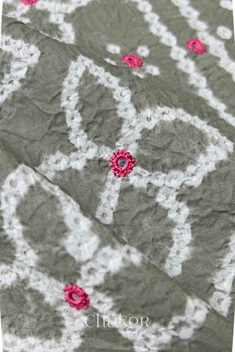 Close-up of Bandhani floral pattern accented with hand embroidery Grey mirror work.
