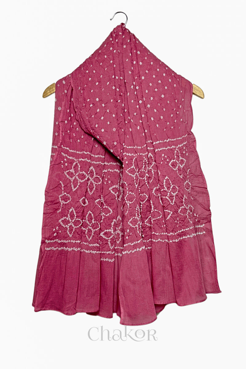 Rose Pink mercerised mulmul cotton dupatta with Bandhani floral pallu design draped on hanger.
