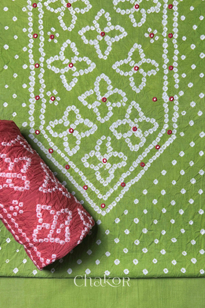 Front yoke detail of Green Bandhani cotton kurta fabric with hand embroidery and mirror work and Dusty Red dupatta rolled up.
