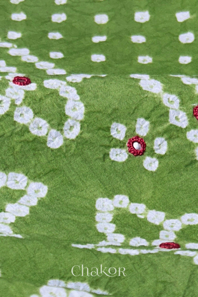 Close-up of Bandhani floral pattern accented with hand embroidery Green mirror work.
