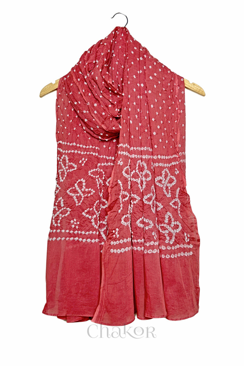 Dusty Red mercerised mulmul cotton dupatta with Bandhani floral pallu design draped on hanger.
