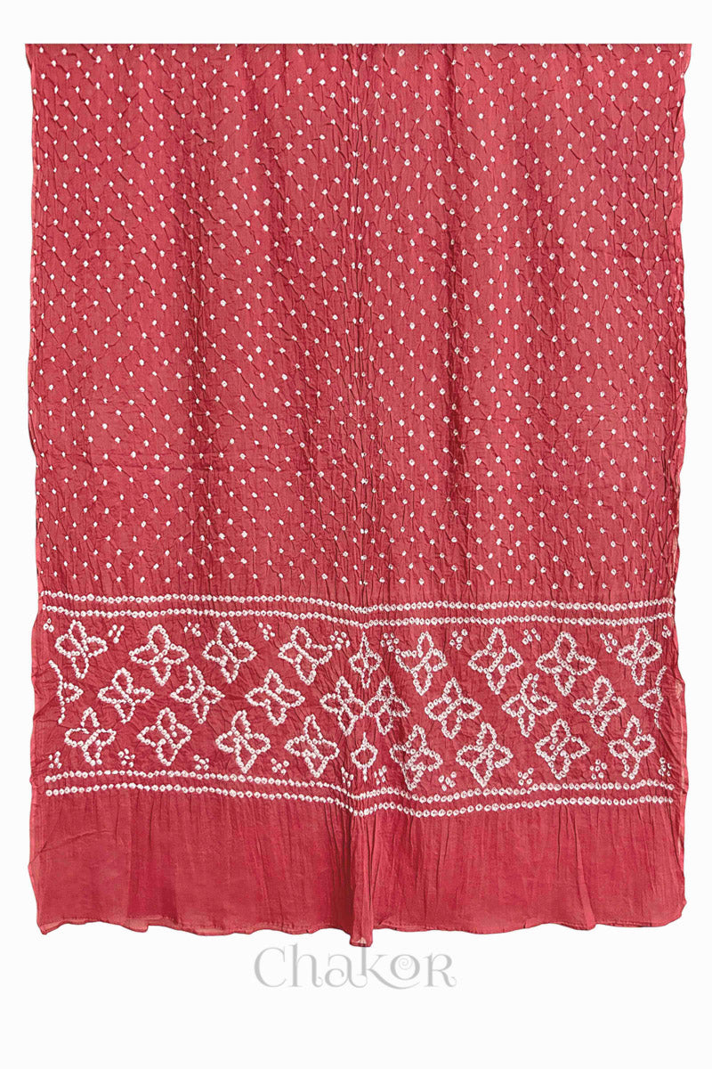 Full view of Dusty Red Bandhani mulmul cotton dupatta with floral pallu and dotted body pattern.
