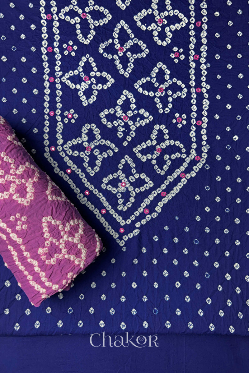 Front yoke detail of Navy Blue Bandhani cotton kurta fabric with hand embroidery and mirror work and Mauve dupatta rolled up.
