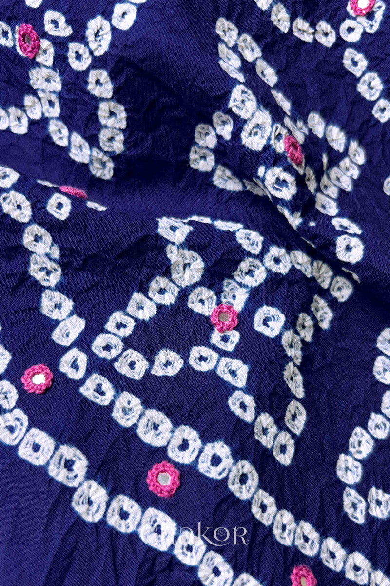 Close-up of Bandhani floral pattern accented with hand embroidery Navy Blue mirror work.
