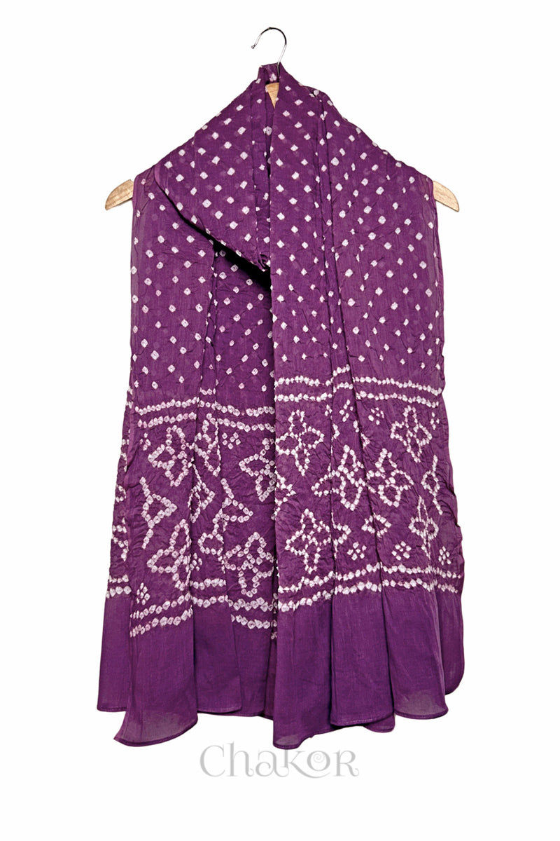 Mauve mercerised mulmul cotton dupatta with Bandhani floral pallu design draped on hanger.
