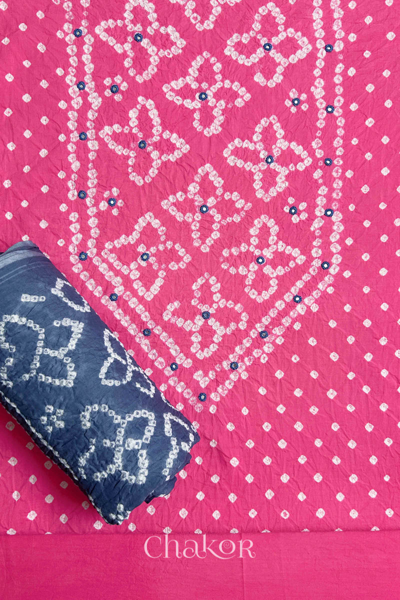 Front yoke detail of Pink Bandhani cotton kurta fabric with hand embroidery and mirror work and Grey dupatta rolled up.
