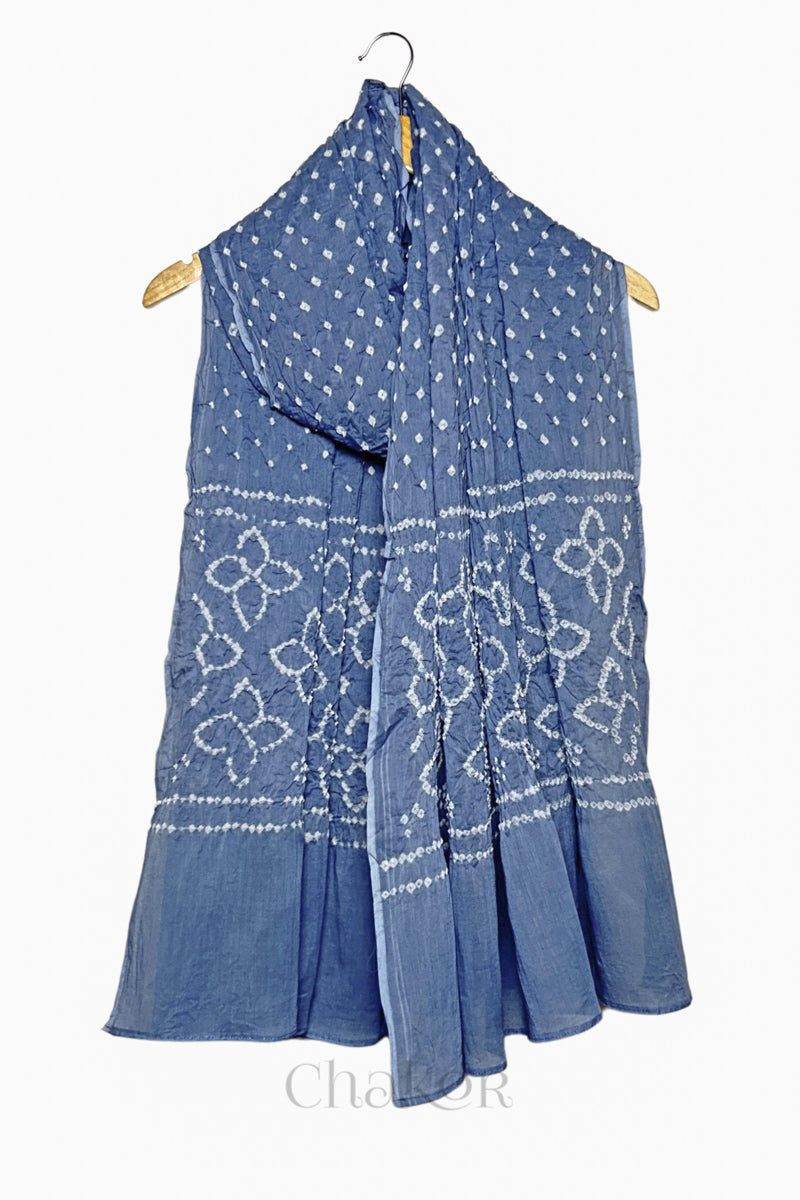 Grey mercerised mulmul cotton dupatta with Bandhani floral pallu design draped on hanger.
