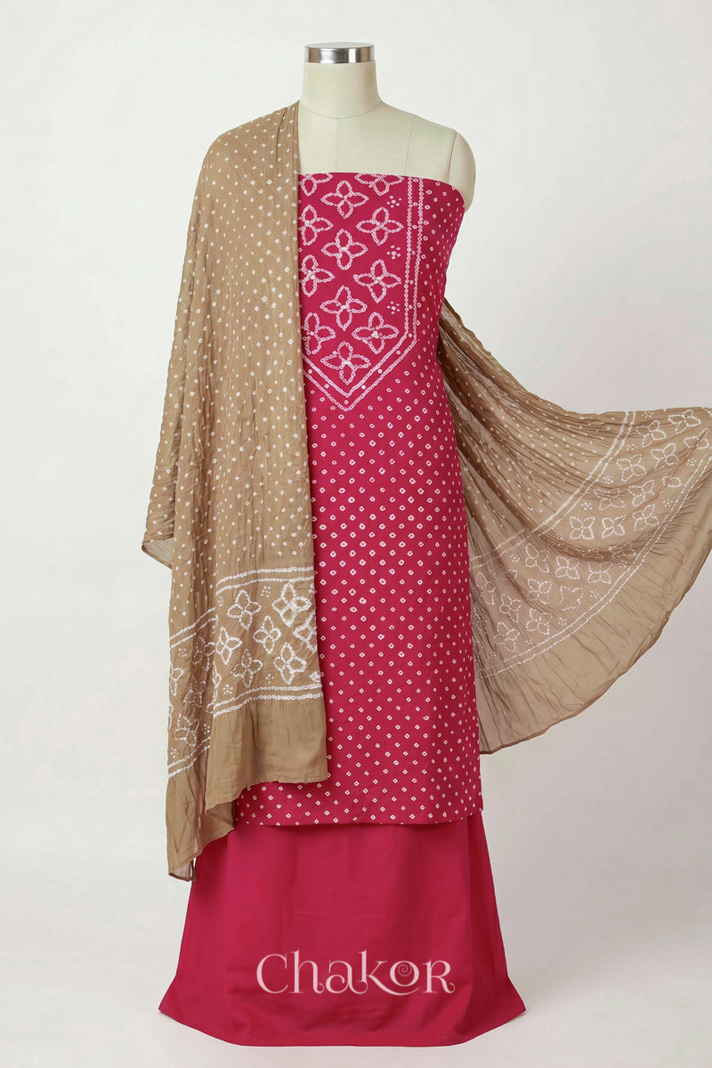Strawberry Pink Kutch Bandhani cotton unstitched suit set, mirror work kurta with Beige mulmul cotton dupatta.
