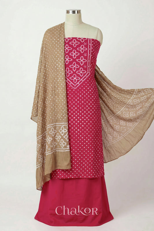Strawberry Pink Kutch Bandhani cotton unstitched suit set, mirror work kurta with Beige mulmul cotton dupatta.
