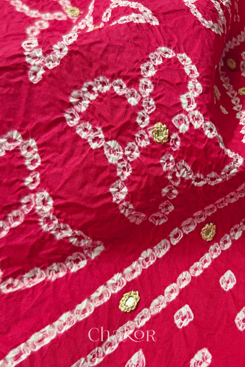 Hand tied Bandhani floral motif with colourful mirror embroidery on Strawberry Pink cotton fabric.
