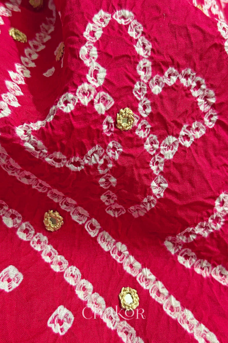 Close-up of Bandhani floral pattern accented with hand embroidery Strawberry Pink mirror work.

