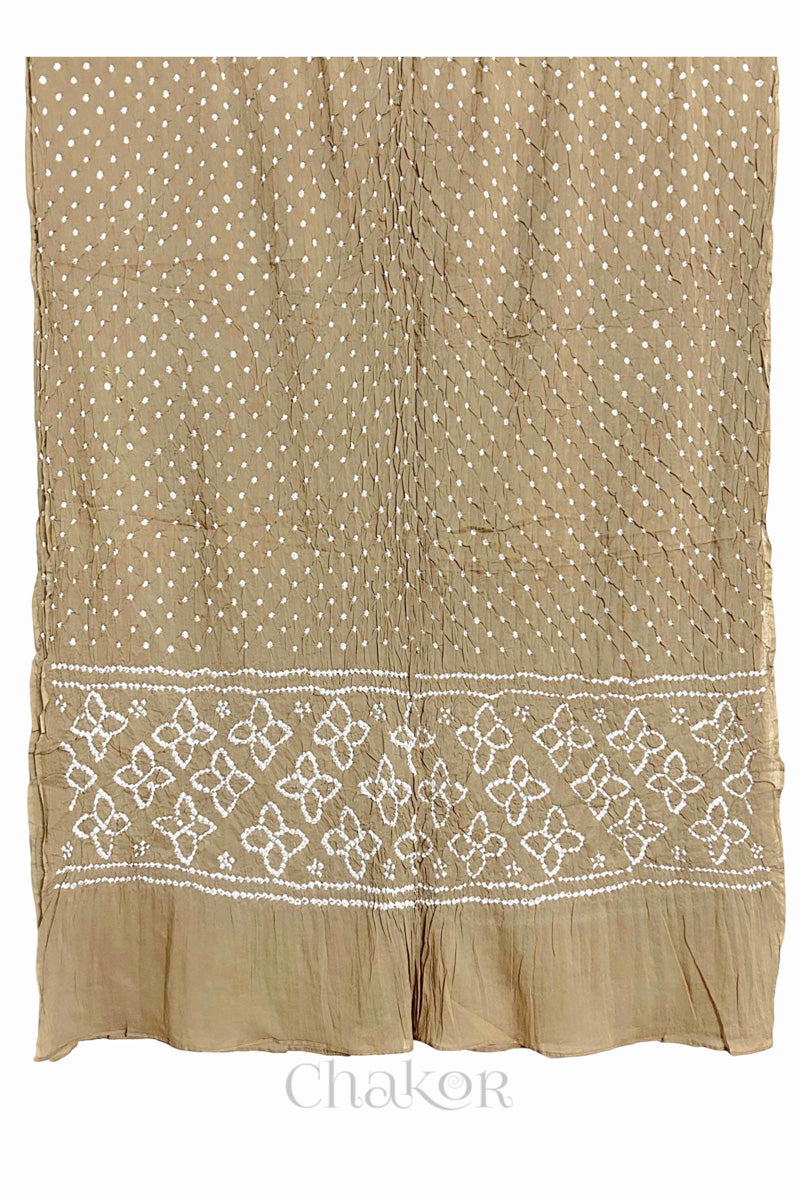 Full view of Beige Bandhani mulmul cotton dupatta with floral pallu and dotted body pattern.
