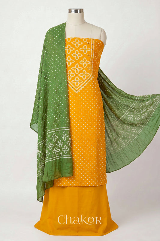 Yellow Kutch Bandhani cotton unstitched suit set, mirror work kurta with Green mulmul cotton dupatta.

