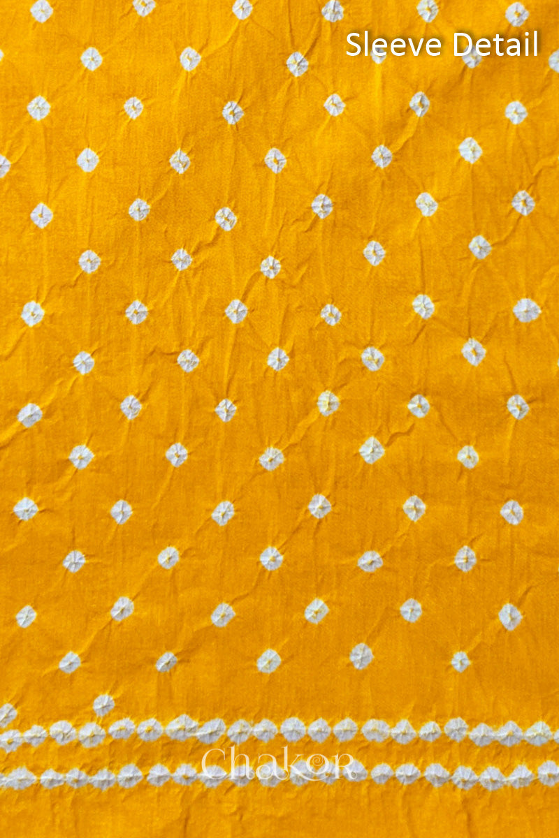 Bandhani dotted sleeve pattern on mercerised cotton fabric with handcrafted tie dye work.
