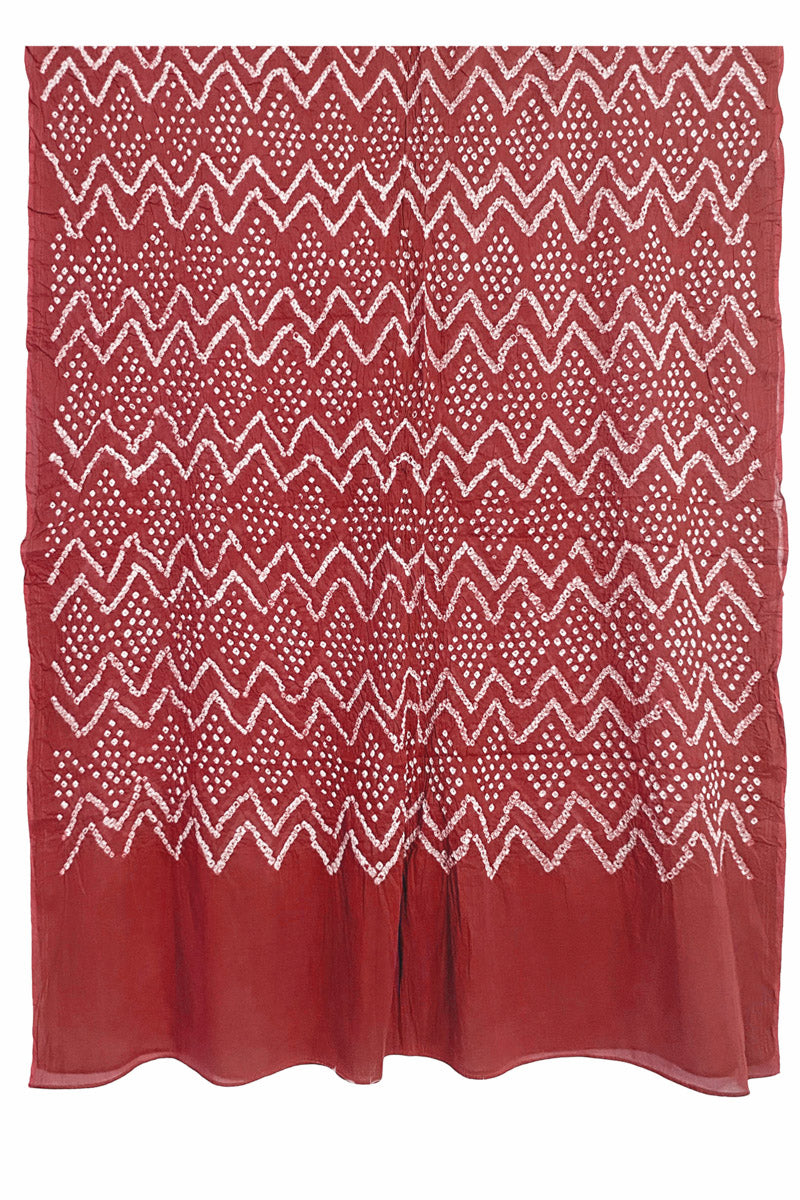 Full view of the brick red dupatta from the kurta set with intricate zigzag bandhani patterns, with Chakor logo. The design showcases artisanal craftsmanship.
