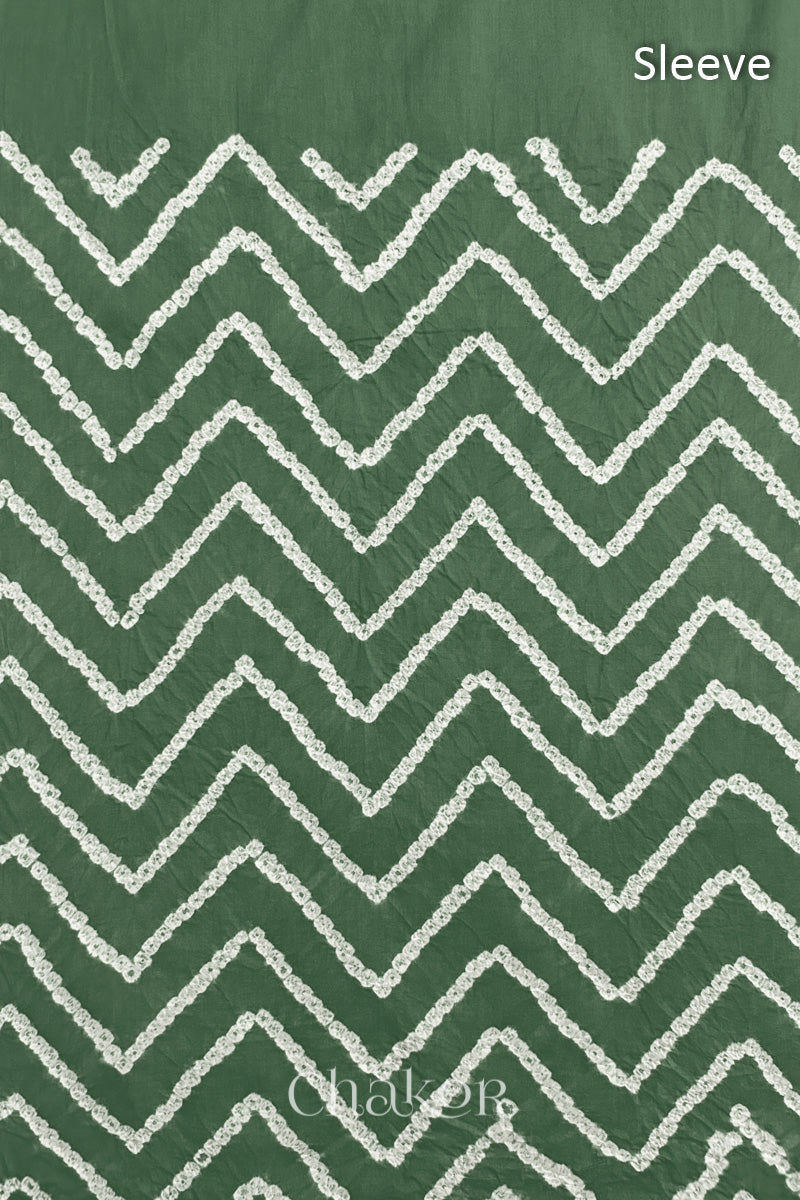 Close-up of  moss green bandhani fabric featuring chevron tie-dye design, with Chakor brand logo. Text reads sleeve details.