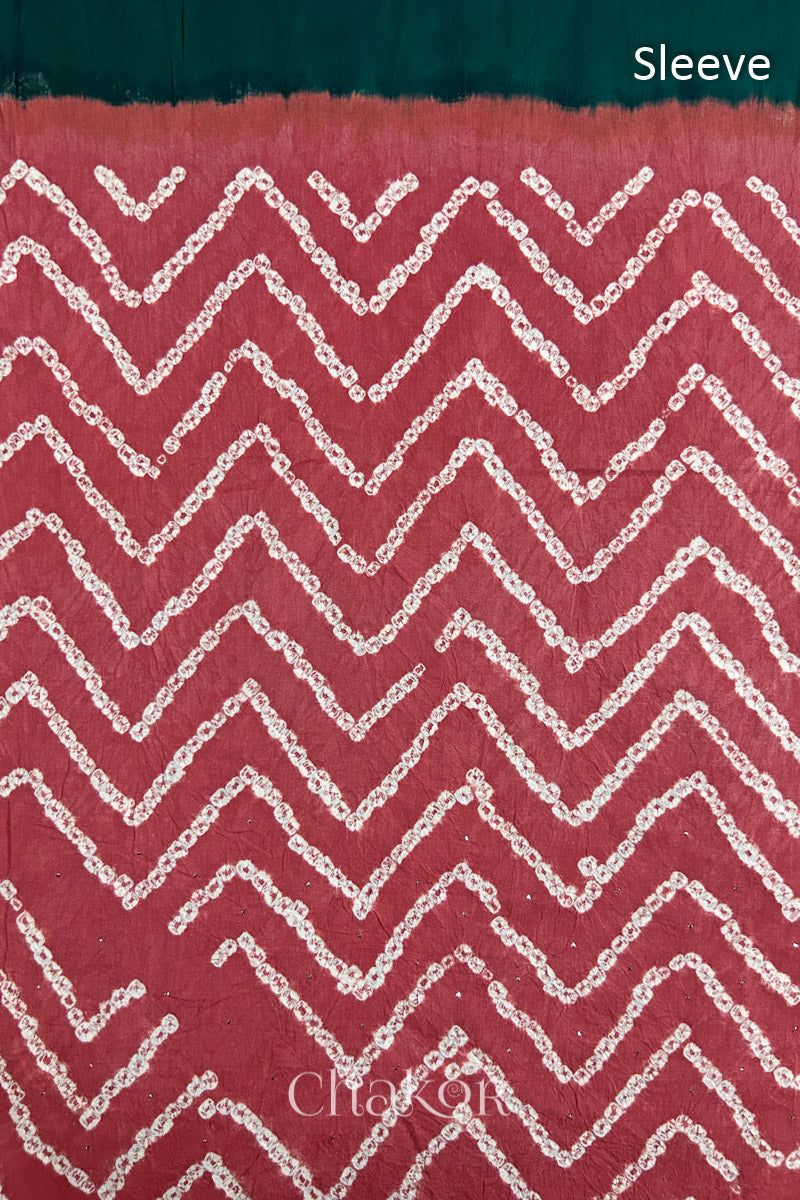 Close-up of dusty red bandhani fabric featuring chevron tie-dye design, with Chakor brand watermark. Text reads sleeve.