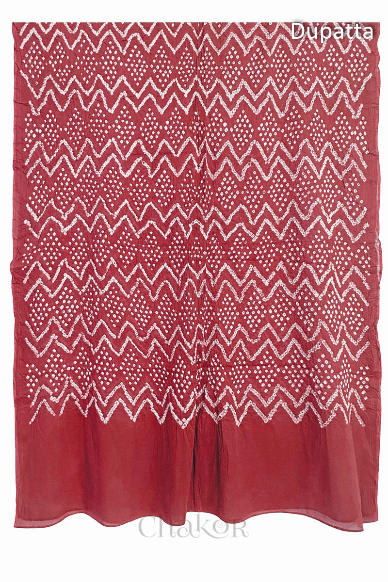 Full view of the dusty red dupatta from the kurta set with intricate zigzag bandhani patterns, with Chakor watermark. The design showcases artisanal craftsmanship.
