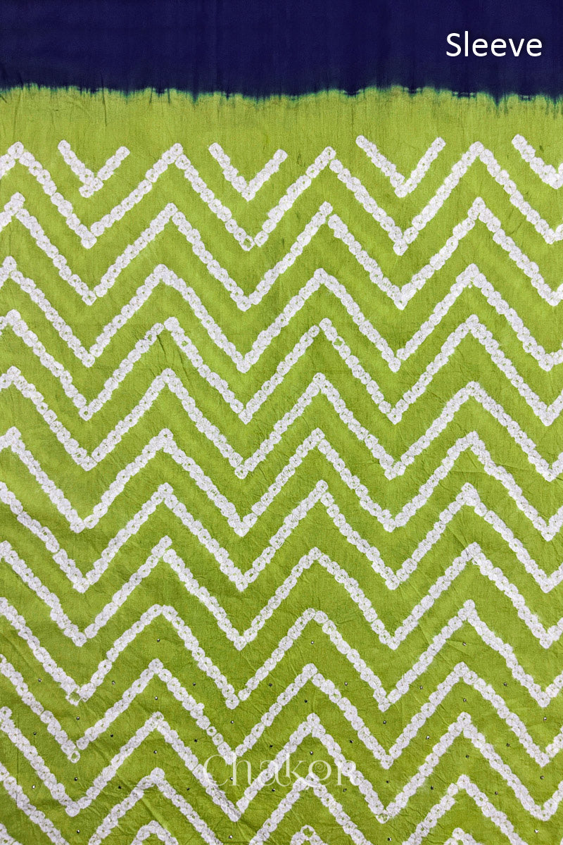 Close-up of lime green bandhani fabric featuring chevron tie-dye design, with Chakor brand watermark. Text reads sleeve.
