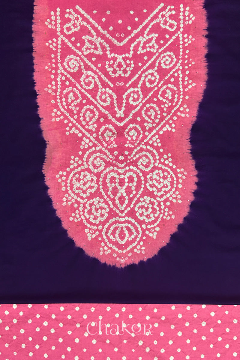 Close-up of dark purple kurta fabric featuring intricate bandhani & pink mukaish embroidered yoke with bandhani dotted bottom fabric, with Chakor brand watermark.
