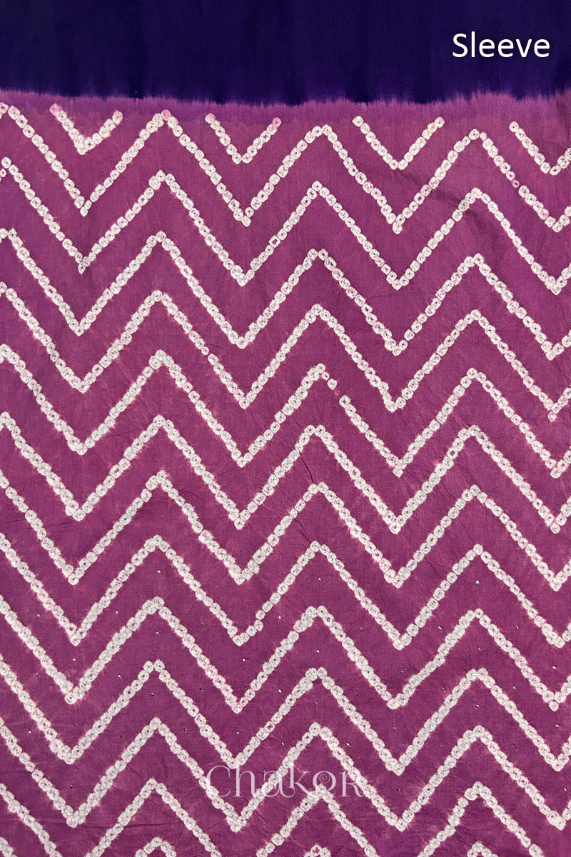 Close-up of violet puprle bandhani fabric featuring chevron tie-dye design, with Chakor brand watermark. Text reads sleeve.
