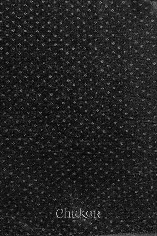 Black mashru self textured fabric with 'Chakor' logo visible.