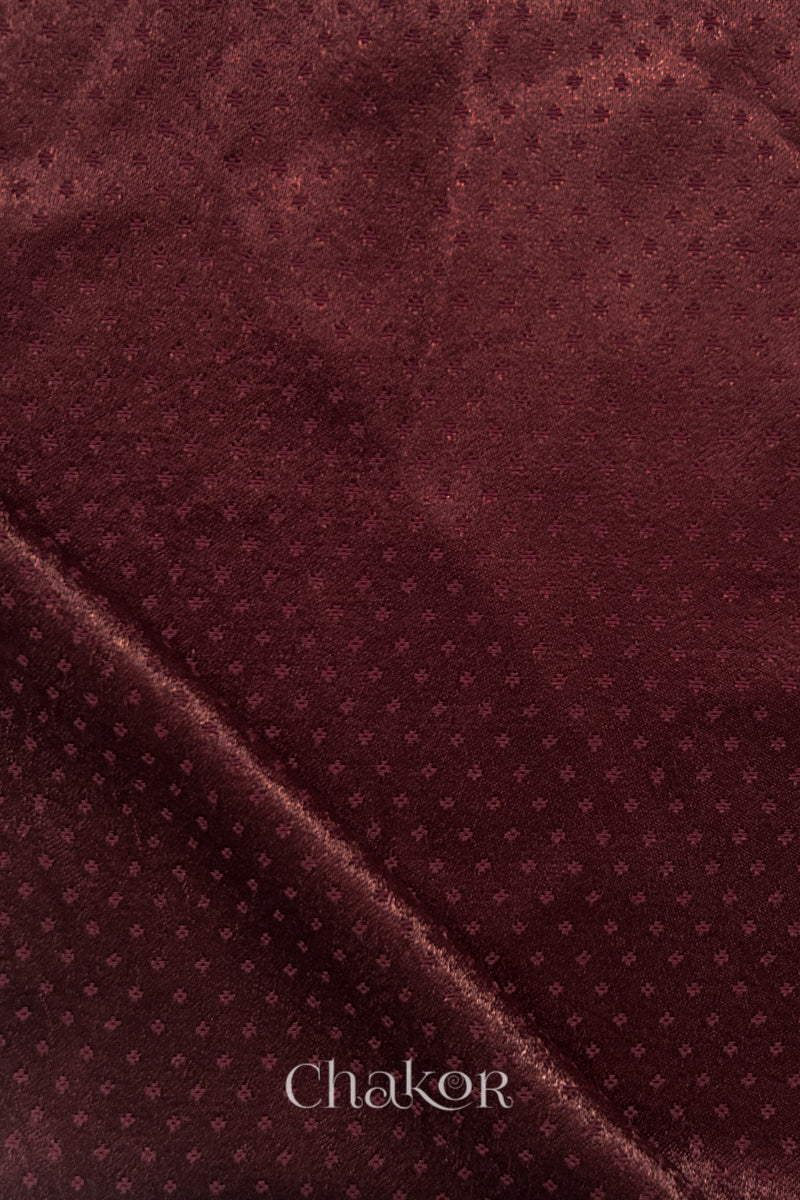 Maroon mashru self textured fabric with folded corner & Chakor brand watermark.
