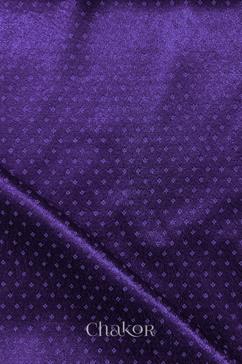 Purple Mashru fabric folded edge detail with subtle sheen.
