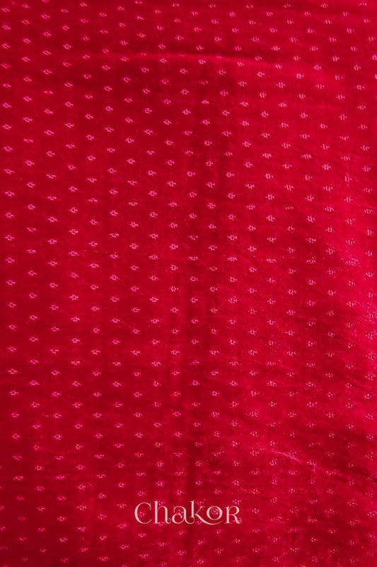 Red mashru self textured fabric with 'Chakor' logo visible.