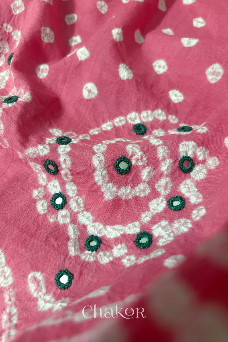 Detail of Kutch Bandhani Keri pattern with mirror embroidery on Pink cotton blouse fabric.
