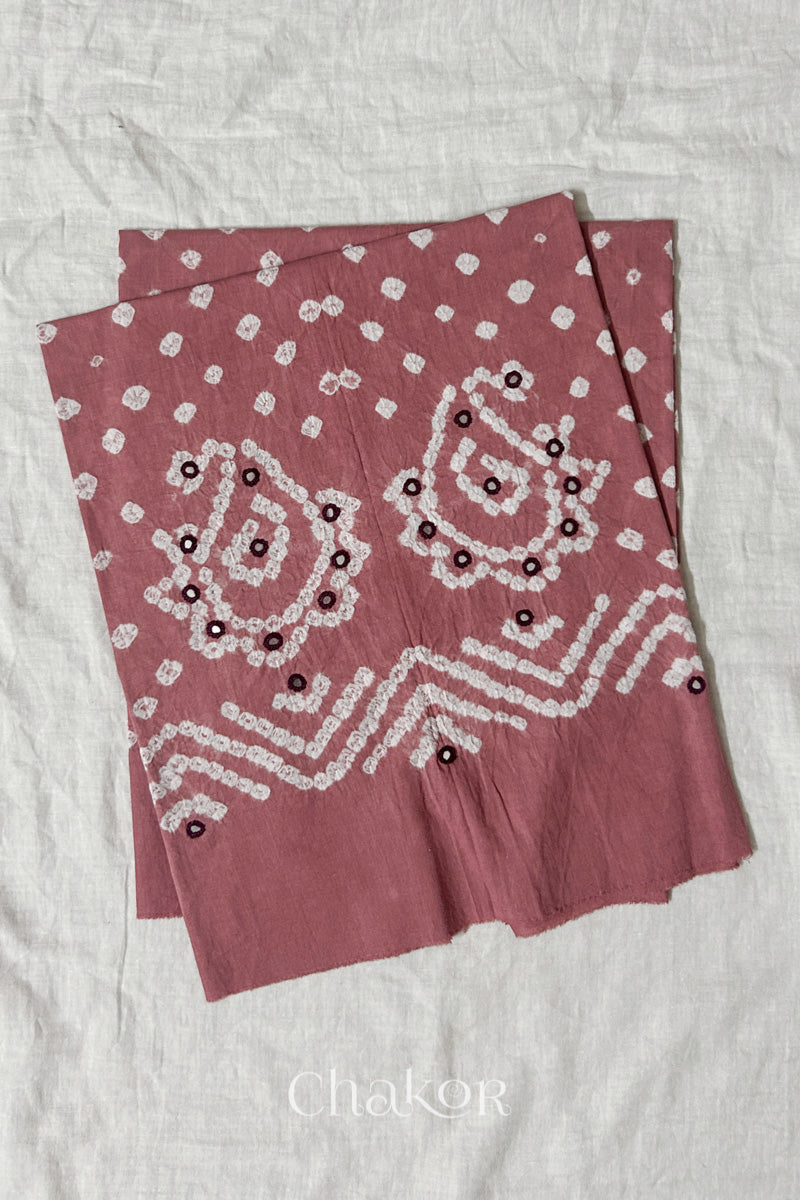 Turquoise Kutch Bandhani cotton unstitched blouse fabric with Keri pattern piece folded on white fabric.
