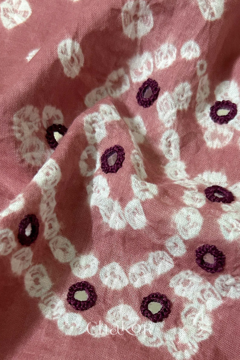 Close-up of Turquoise Kutch Bandhani blouse fabric showing Keri motifs and hand-embroidered mirror work.
